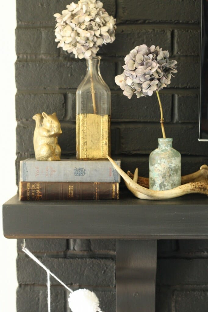 #EclecticallyFall mantle with gold, brass, antlers, and dried hydrangeas