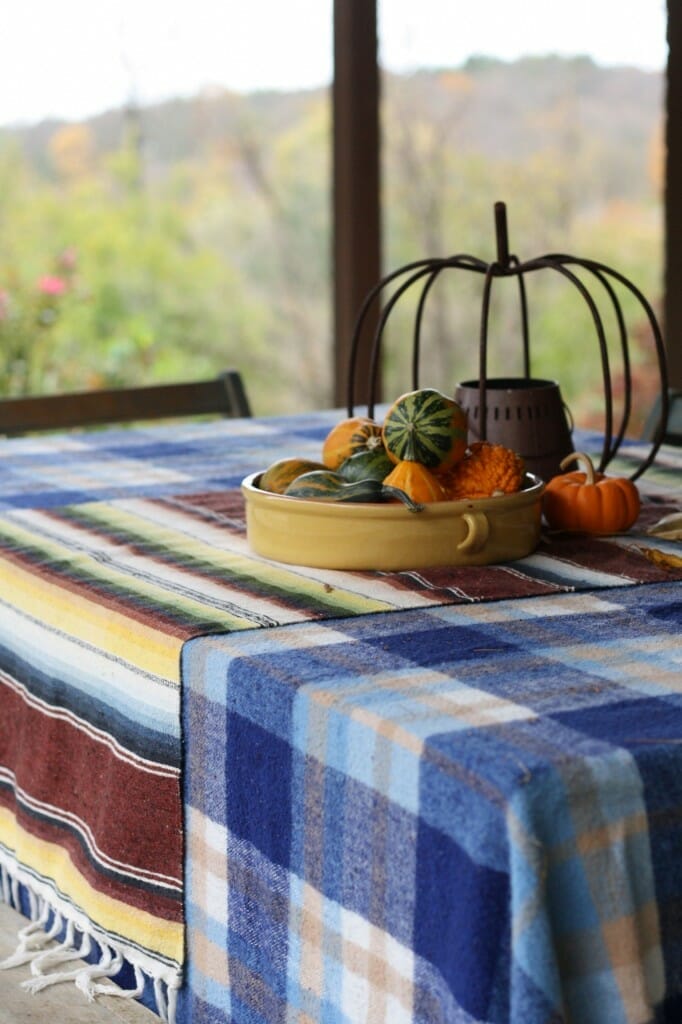 layered plaid and mexican blankets as tableclothes