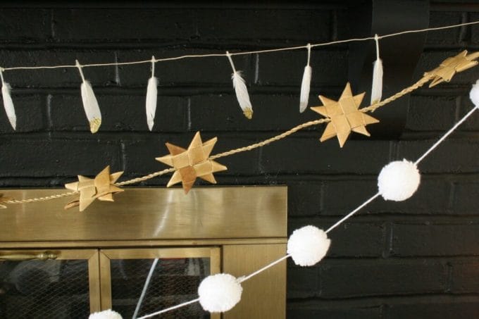 Mantle with feather garland, pom pom garland, and rustic moravian star garland
