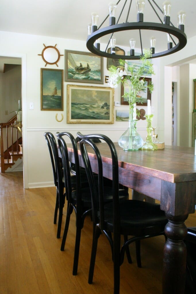 Black bentwoods in dining room, vintage nautical gallery wall