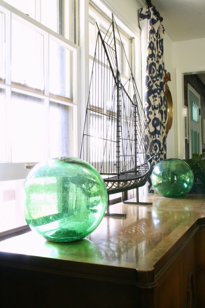 Green Glass Floats on Sideboard