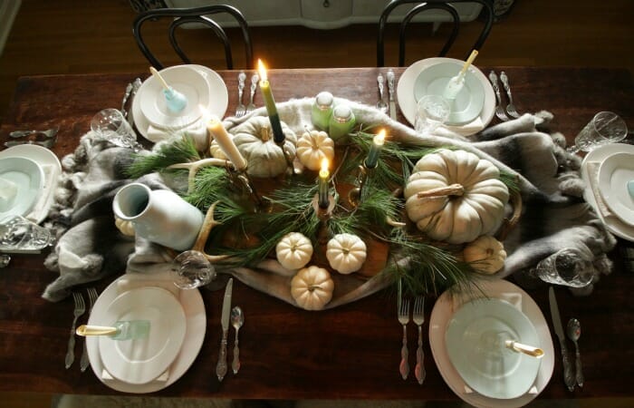 Thanksgiving table in blues and greens with pine and pumpkins