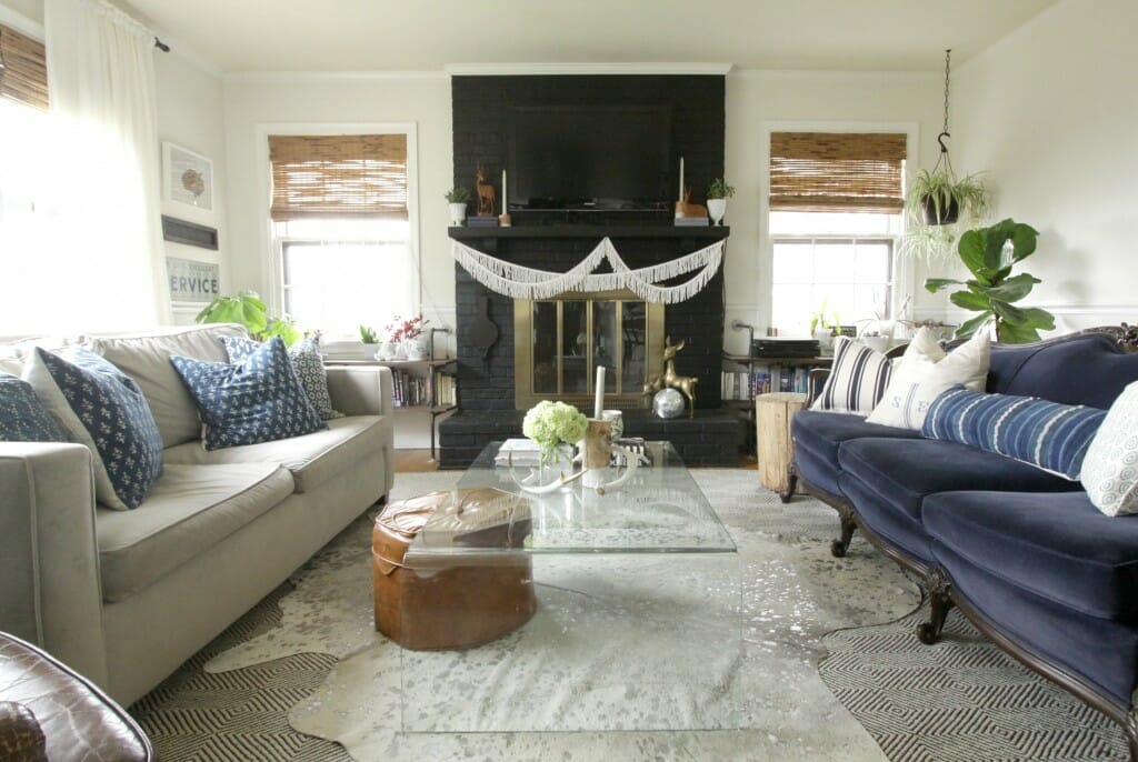 Eclectic Living room in blue, white, black, with glass coffee table and vintage sofa