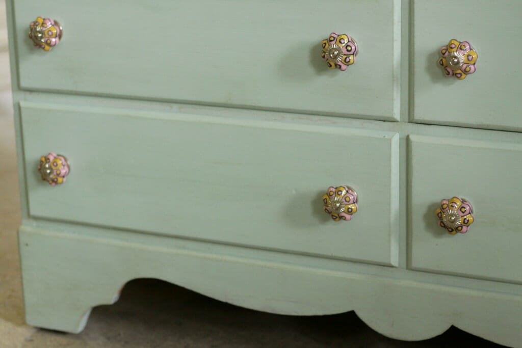Scalloped details of mint dresser