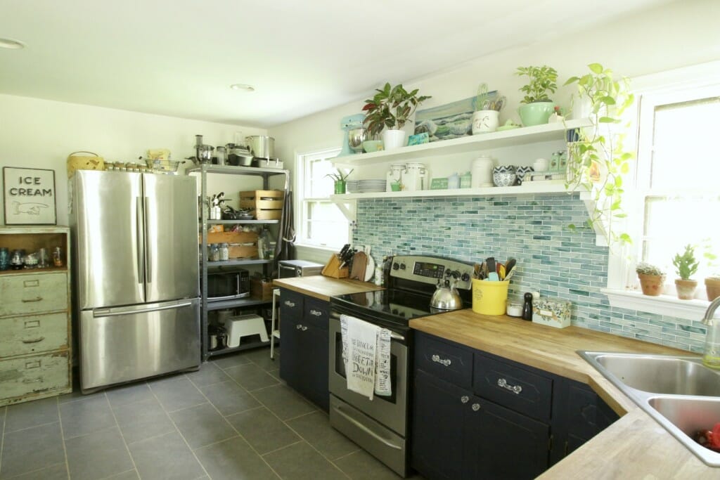 Eclectic Kitchen with Navy Cabinets and aqua recycled glass backsplash