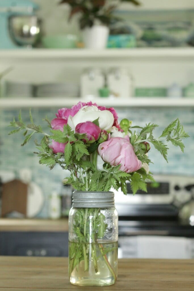 Jar of peonies on kitchen island