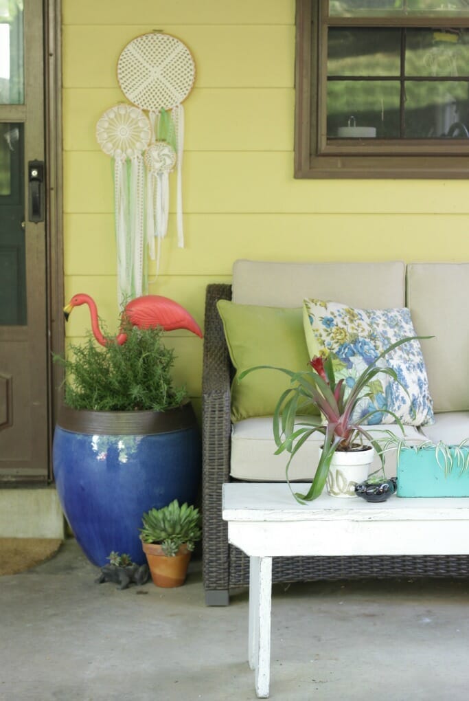 White bench as coffee table on porch- bohemian and eclectic porch