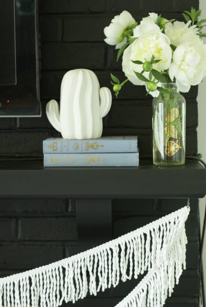 Cactus, Fringe, Peonies in white on black fireplace mantle