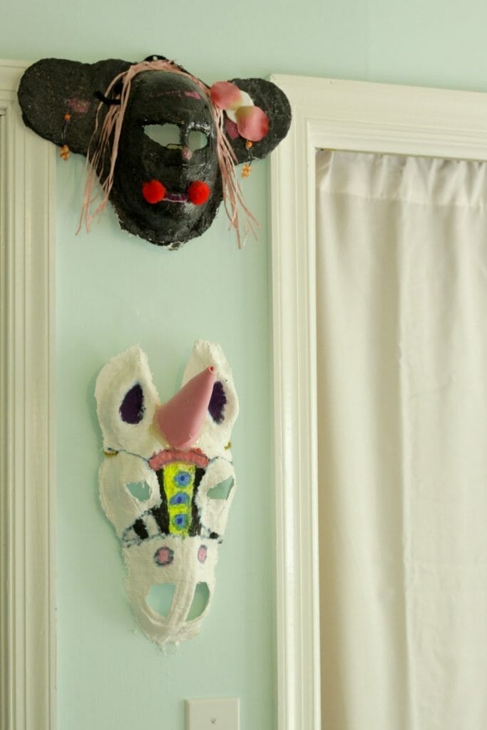 Handmade child's masks in bedroom