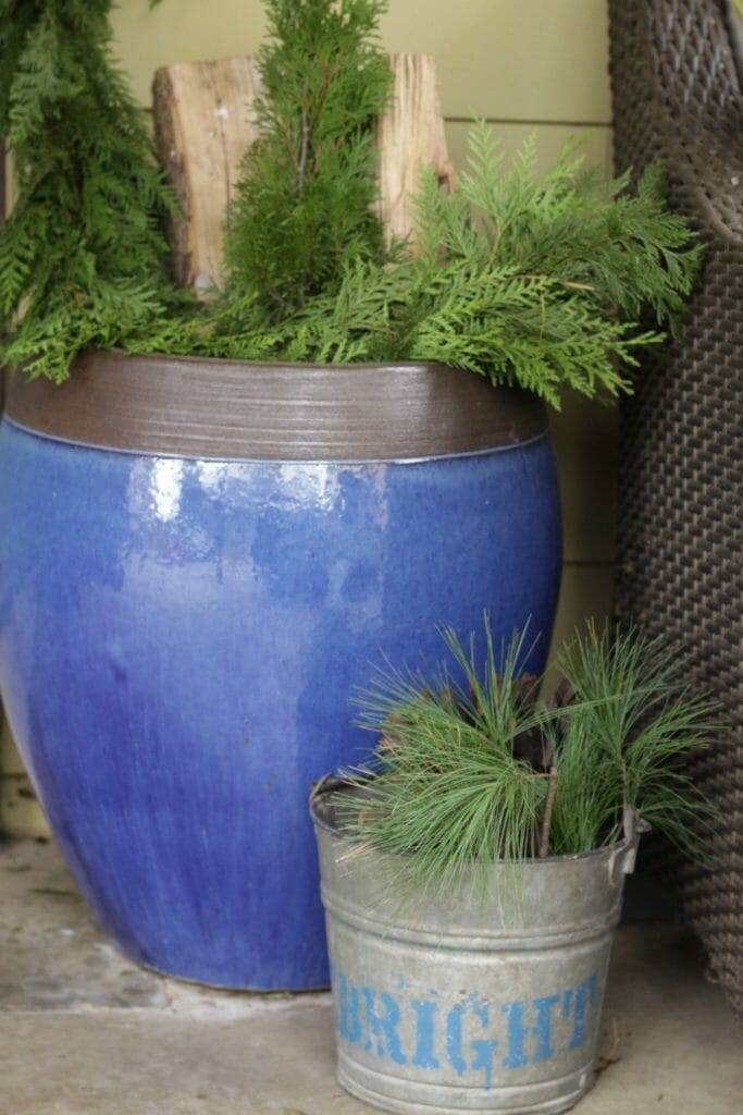 Blue Urn with Greenery and Firewood