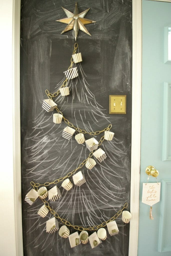 DIY Advent Calendar with chains and treat boxes on chalkboard wall