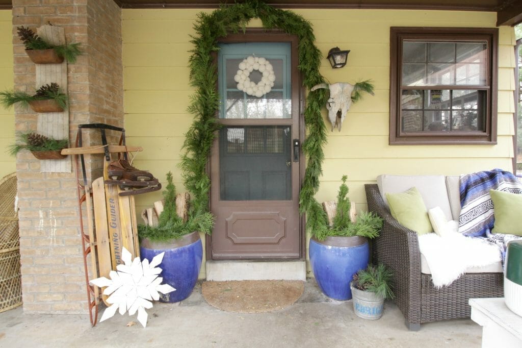 Eclectic Blue & Green Christmas Porch with Greenery and Vintage Touches