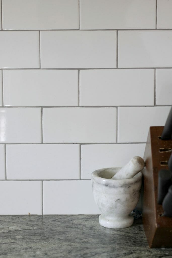 White Subway tile with gray grout backsplash
