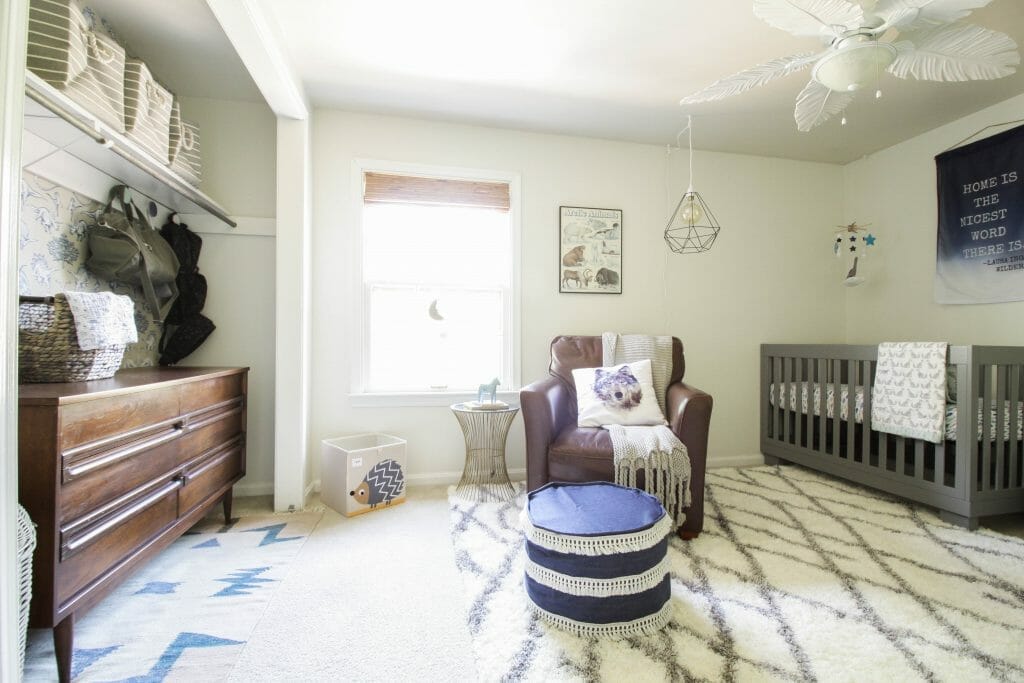 boys nursery in blue white gray featuring wallpapered closet
