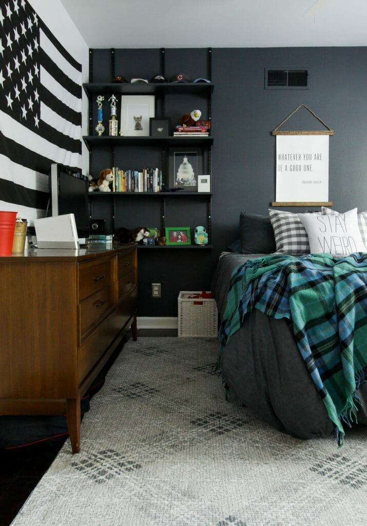 moody teen boy bedroom with touches of plaid and track shelving
