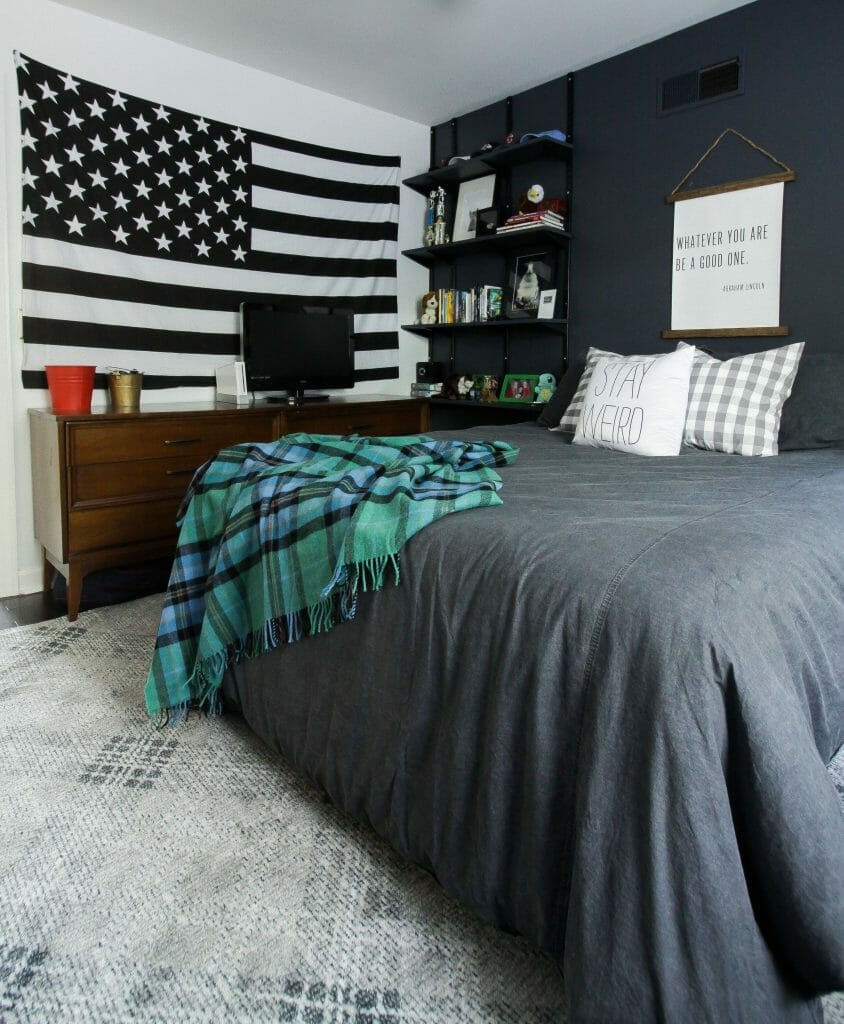 moody teen boy bedroom with touches of plaid and budget track shelving
