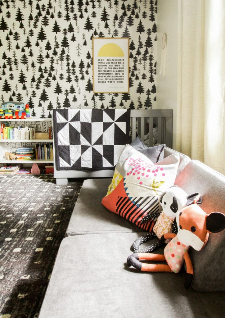 adorable nursery with black and white tree wallpaper