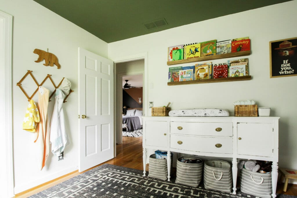 painted green ceiling in nursery with vintage sideboard as changing table