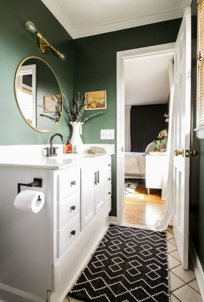 dark green bathroom with black and gold accents