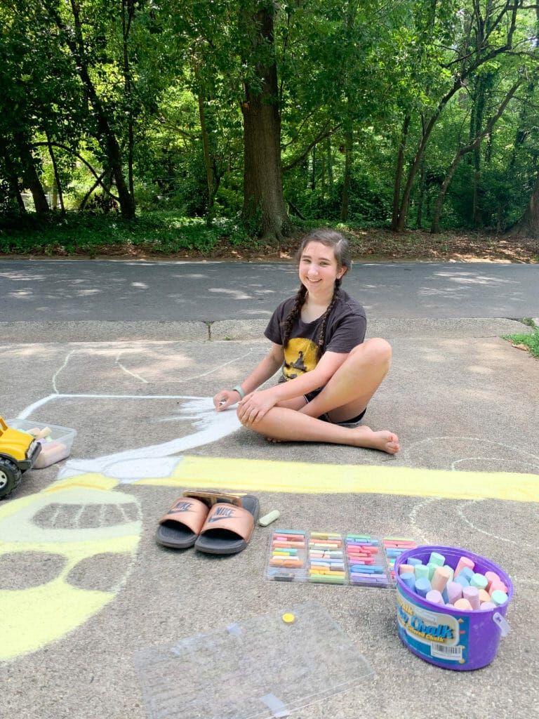 Emmy drawing in the driveway