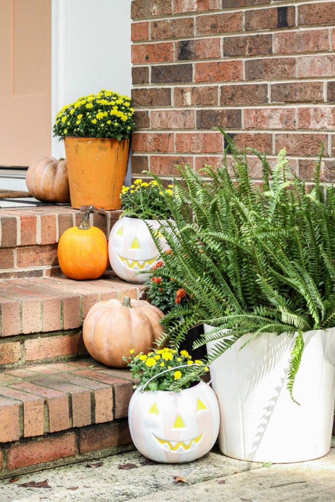 DIY painted plastic pumpkin buckets for outside