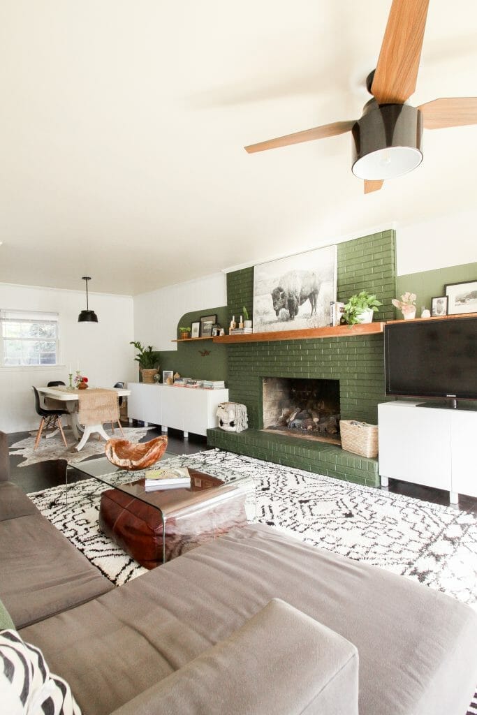 modern boho family room with green fireplace