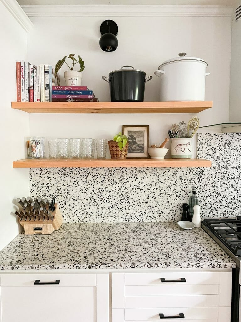 kitchen with open shelving and terrazzo